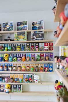 the shelves are filled with many different toy figurines