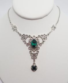 This is a new handmade necklace. It is made with antiqued silver plated filigrees, accented with high quality EMERALD GREEN glass jewels/rhinestones that sparkle like crystals. Decorated portion is 4 1/2" wide and 2 1/4" tall in the center. Necklace is adjustable 15-18" with a lobster clasp and chain extender. If you would like a different length, please send us a message.Matching earrings and headpiece are listed in our store in a variety of stone colors. If you don't see items with a color you Antique Silver Necklace, Silver Jewlery, Green Prom, Antique Jewelry Necklace, Jewelry Board, Character Aesthetics, Medieval Jewelry, Choker Pendant, Prom Jewelry