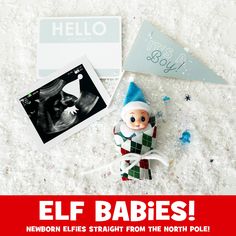 an elf baby doll sitting on top of a white carpet next to a christmas card