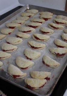 a pan filled with pastries sitting on top of a stove