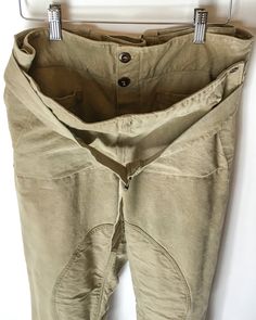 Subdued olive green canvas work pants. Padded legs, front buttons in a sailor style fashion, drop down front with “interior” front pockets, buckle cinch at leg hems and waist. Note: Openings at side “pockets” as these are intended as over pants. See photo. Fabric: CanvasFit: M|L up to 34 inches Measurements (flat): Waist 17 inches (can adjust smaller) Hips 19.5 inches Rise 13.5 inches Inseam 28.5 inches Length 40.5 inches Leg opening 9.75 inches Condition: Excellent Khaki Linen Cargo Pants With Pockets, Olive Linen Bottoms With Pockets, Olive Cargo Pants For Workwear With Belt Loops, Military Style Olive Workwear Bottoms, Olive Military Style Work Bottoms, Olive Trousers With Belt Loops, Khaki Parachute Pants With Belt Loops And Tapered Leg, Utility Style Khaki Bottoms With Button Closure, Khaki Utility Bottoms With Button Closure