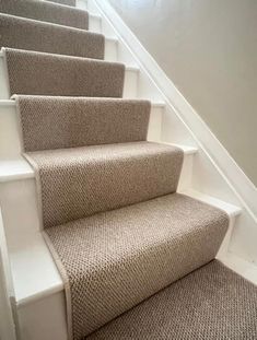 carpeted stairs leading up to the second floor