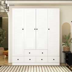 a large white closet with many doors and drawers in the middle of a living room