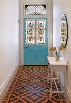 the front door is painted in turquoise and orange