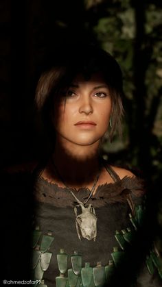 a woman with dark hair and an animal head on her shirt is looking into the camera