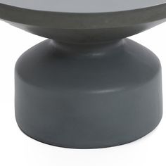 a round table with a metal base on it's top, against a white background