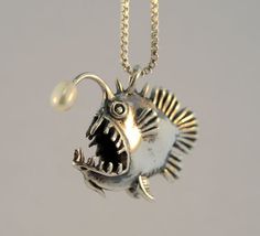 This solid sterling silver Angler Fish Charm is 1" long. This whimsical Angler Fish is detailed both front and back and stands freely, balancing on it's lower fins. A fresh water, cultured pearl is set at the tip of it's lure. May this grotesque but personable fish amuse and delight you! -From Etsy Fish Beaded Necklace, Fish Clothes, Angry Fish, Fish Jewelry, Fish Necklace, Fish Pendant, Angler Fish, Earrings Art, Finding Nemo