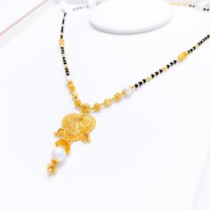 PRODUCT DETAILS Gold Purity(karat): 22k Item Weight(grams): 14.6 Item Finish: Yellow Gold Stone: Black Bead + Pearl Necklace Length: 18.5" Drop Length: 1.5" Adjustable Links: ﻿1.6" Lock Style: Hook Lock Gold Pearl Necklace With Black Round Beads, Elegant Black Temple Necklace For Festive Occasion, Elegant Black Temple Necklace For Wedding, Black Necklace With Intricate Design For Festivals, Black Necklaces With Intricate Design For Festivals, Black Intricate Design Necklace For Festivals, Elegant Black Temple Necklace As Gift, Elegant Black Beaded Jewelry For Puja, Elegant Black Temple Necklace Gift