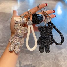 a hand holding several different types of key chains