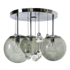 three clear glass balls hanging from a ceiling fixture