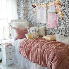 a bedroom decorated in pink and white with leopard print wallpaper