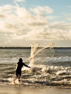 a person standing in the water with a net