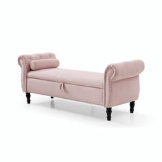 a pink chaise lounger with black legs and buttons on the armrests