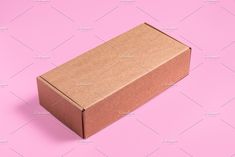 an open cardboard box on a pink background