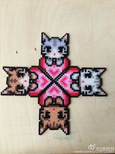 the cross is made up of cats in different colors and sizes, with one cat on top of the other