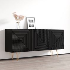 a black and gold sideboard in a white room