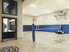 an indoor basketball court with a net in the middle