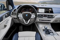 the interior of a car with dashboard, steering wheel and center console in front of it