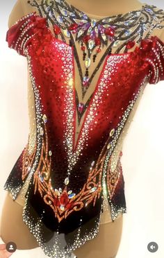 a woman wearing a red and black leotard with sequins on it