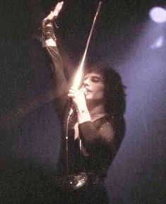 a woman holding a microphone in her right hand