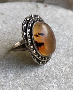 Art Deco 1920s Sterling Silver Marcasite Orange Banded Agate Vintage Ring Please see pictures of ring next to ruller for scale Ring size 6 Vintage Agate Rings For Anniversary, Antique Amber Round Ring, Antique Oval Ring With Stone Setting, Vintage Hallmarked Round Opal Ring, Vintage Rings With Natural Inclusions For Gift, Vintage Opal Ring Collectible, Vintage Style Cabochon Opal Ring For Formal Occasions, Vintage Opal Ring For Formal Occasions, Vintage Agate Gemstone Rings