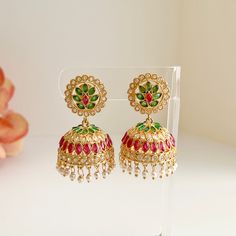 Large green and red cubic zirconia jhumkas will beautifully compliment your traditional attire!   Length 2" | Width 1.5" Items are carefully packed and ready for gifting. All pictures are taken in natural light please allow for slight variations in color due to camera settings. Jewelry Care ✨Protect your jewelry in a closed box or pouch   ✨Wear jewelry after you have applied lotion or perfume ✨Gently buff with a soft cotton cloth  Visit our website: www.desimoon.etsy.com Thank you for visiting a Festive Ruby Jhumkas For Celebration, Bollywood Ruby Jhumkas For Celebration, Heavy Ruby Jhumkas For Gift, Green Indian Earrings, Ruby Hand-set Jhumkas As Gift, Festive Red Ruby Jhumkas, Earrings Chandbali, Polki Earrings, Chandbali Earrings