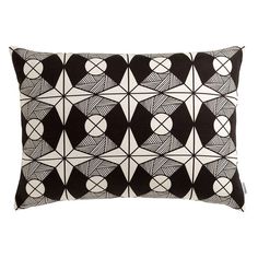 a black and white pillow with geometric designs on the front, along with an embroidered back