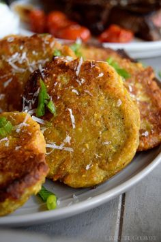 some food is on a white plate with green garnish and parmesan cheese