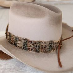 The Moab Western Feather Hat Band features a width of 3 cm and an approximate length of 58 cm, not including the leather ties. This adjustable hat band fits most sizes, with leather ties ensuring a secure and customizable fit. Its feather detailing adds a touch of western sophistication, making it a stylish enhancement for any hat. Feather Hat Band, Hat Bands, Feather Hat, Cowgirl Hat, Pets For Sale, Cowboy Boots Women, Cowgirl Hats, Cowboy And Cowgirl, Hat Band