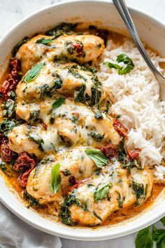 a white bowl filled with chicken, spinach and rice