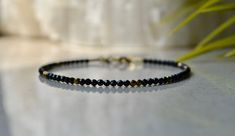 "Tiny black spinel beaded gemstone bracelet with hematite gold beads and gold vermeil claps, bracelet femme is a perfect bridesmaid gift or anniversary present. . ❗️Sign up to our Newsletter and get 15% OFF your order (copy this link to browser search) - https://forms.gle/R74xLdL1MSmC9Apn6 ❗️ . Price is for ONE bracelet ONLY. . MEASUREMENTS: Beads: Black Spinel 2 mm; gold-plated hematite - 2 mm Clasp: Gold vermeil (gold plated 925 sterling silver) Length: You can choose the length of the bracele Unique Beaded Bracelet, Garnet Bracelet, Etsy Bridesmaid Gifts, Quartz Bracelet, Jewelry Bracelet, Gemstone Bracelets, Dainty Jewelry, Gemstone Bracelet, Bridesmaid Gift