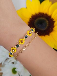 Bracelet with sunflowers 🌻 jewelry with flowers | flowered bracelet | boho | fashion jewelry |  friendship bracelet | bracelet girl, woman | elegant bracelet | sunflower bracelet -Measure This bracelet is made up of small flowers of approximately 9 mm I recommend measuring your wrist circumference before purchasing. Each bracelet also has a small stainless steel chain of approximately 4 cm - Material Glass beads Nylon thread Gold plated stainless steel -Care instructions To keep this delicate bracelet for a long time we recommend: Avoid direct contact with perfumes, cream, soaps and other chemicals. Do not use this bracelet while sleeping, playing sports or showering/bathing. There are also other sizes and types of shipments Thank you !! For any information contact me privately without pr Cheap Yellow Flower Shaped Beaded Bracelets, Elegant Yellow Flower Bracelet, Sunflower Beaded Bracelet, Gold Flower-shaped Beaded Bracelets, Cheap Yellow Flower-shaped Beaded Bracelets, Adjustable Daisy-shaped Bracelet With Flower Charm, Sunflower Bracelet, Jewelry Friendship, Fall Bead