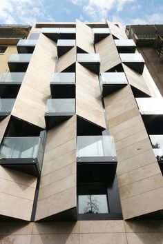 a tall building with many windows and balconies