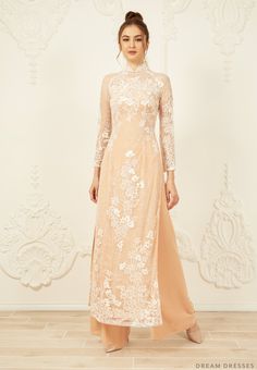 Custom made dusty pink Ao Dai Materials: lace, tulle, chiffon Collar: 1.8in/4.5cm tall collar Long sleeves Closure: zipper Chiffon pants Made to measure Champagne Ao Dai, Beige Wedding Dress With Intricate Embroidery, Elegant Floral Embroidery Wedding Dress For Ceremony, Elegant Wedding Dress With Floral Embroidery For Ceremony, Elegant Wedding Dress With Floral Embroidery, Elegant Pink Ao Dai With Floral Embroidery, Elegant Floral Embroidered Maxi Dress For Wedding, Beige Dress With Intricate Embroidery For Reception, Wedding Ao Dai With Intricate Embroidery