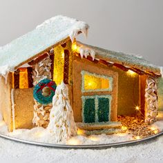 a gingerbread house decorated with icing and lights