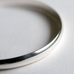 This gorgeous and  simple bangle has been handmade in sterling silver and given a super shiny finish.  It is a solid and comfortable bracelet that will work perfectly everyday and is sure to become a staple in your life.  Wear it alone or stacked with other bangles.Measures approx. 6mm x 2mmAvailable in,X Small 2.25 inches diameter,  7.5 inch circumferenceSmall 2.5 inches diameter, 8 inch circumferenceMedium 2.75 inches diameter, 8.5 inch circumferenceLarge 3 inches diameter, 9 inch circumferenc Minimalist Polished Bangle, Classic Adjustable Sterling Silver Bracelet With Shiny Finish, Modern Sterling Silver Bracelet With Polished Finish For Everyday, Sterling Silver Bracelet With Polished Finish For Everyday, Polished Sterling Silver Bracelet For Everyday, Minimalist Round Cuff Bracelet With Polished Finish, Minimalist Cuff Bracelet With Polished Finish, Everyday White Gold Sterling Silver Bracelet With Polished Finish, Modern Silver Bangle For Everyday