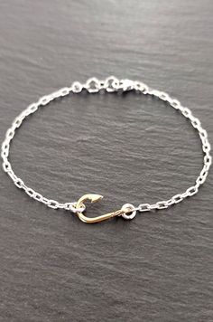 The T'AMO bracelet by Calcagnini Gioielli was made by hand and is made up of a realistic 18 kt yellow gold fishing hook with a polished finish and a beautiful sterling silver chain. The bracelet is suitable for both males and females and is available in various sizes. The bracelet are shipped in a beautiful gift box. N.B .: The timing of the realization of this jewel can vary from 7 to 10 days, therefore, from the moment of the order it could take up to 10 days before shipping. Fishing Bracelet, Fishing Hook, Gold Fish, Sterling Silver Bracelet, Beautiful Gift Boxes, Goldfish, Fish Hook, Sterling Silver Bracelets, Sterling Silver Chains