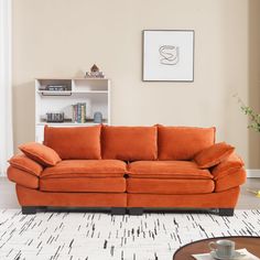 an orange couch sitting on top of a white rug