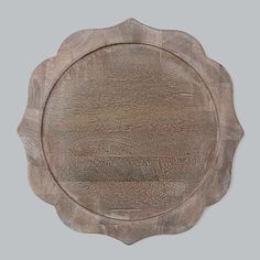 an old wooden plate is shown on a gray background