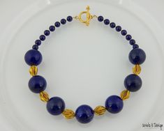 "17\" necklace with 7 dark blue, 22mm round AAA Lapis beads with lovely Pyrite inclusions, 7mm round dark Lapis beads, Hill Tribe Vermeil fancy accent beads, Toggle Clasp that is 24K gold over Sterling Silver. This is a bold necklace with really large (22mm) Lapis beads that are of the highest quality. If you love to wear outstanding Lapis that makes a real impact, then this necklace is one that you would love to own. This is a one-of-a-kind piece that will ship via USPS Priority Mail within 2 b Elegant Royal Blue Round Bead Necklaces, Elegant Royal Blue Round Beads Necklace, Elegant Royal Blue Round Beaded Necklace, Elegant Lapis Lazuli Beaded Necklaces With Round Beads, Elegant Beaded Necklaces With Round Lapis Lazuli Beads, Elegant Lapis Lazuli Beaded Necklace With Round Beads, Elegant Lapis Lazuli Beaded Necklaces, Elegant Round Lapis Lazuli Beaded Necklaces, Elegant Lapis Lazuli Beaded Necklace