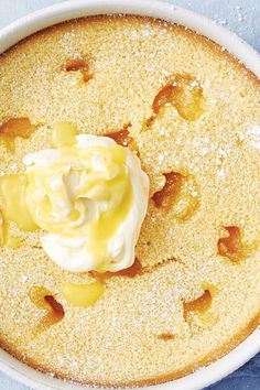 a cake in a white dish with icing on top