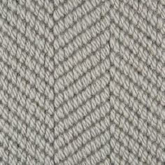 an up close shot of the texture of a knitted fabric in grey and white