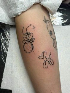 a woman with a tattoo on her arm that has two bugs and a flower in it