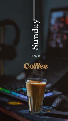 a cup of coffee sitting on top of a computer desk