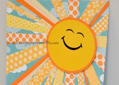 a close up of a smiley face on a piece of paper with sunbursts in the background