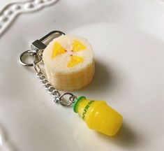 a keychain that has a small piece of food attached to it on a plate