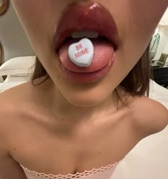 a woman sticking her tongue out with a white button on it's lip that says no time