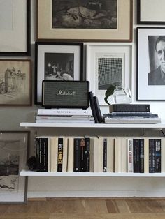 a book shelf with books and pictures on it