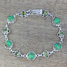 The glistening peridot gemstones are appealing in the design of this handcrafted bracelet from Neeru Goel of India. Combined with green composite turquoise stones amidst a sterling silver setting, the green hues complement each other to create an exquisite piece. The piece fastens with a box hook clasp that features a dot pattern. Peridot Color, Turquoise Earrings Dangle, Handcrafted Bracelets, Classy Jewelry, Peridot Gemstone, Green Peridot, Fancy Jewelry, Jewelry Packaging, Sterling Silver Studs