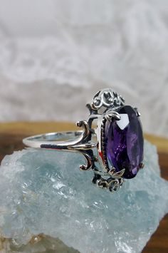 "Natural Purple Amethyst Ring Vampire Design#84 Custom Made Inspired by Gothic & Renaissance era jewelry, I now offer this lovely Antique styles ring in sterling silver. This gorgeous ring is set with a flawless natural 5ct purple amethyst gemstone. This stunning gemstone has excellent color and clarity. The oval full cut oval purple amethyst is 14mm (9/16th of an inch) Long by 10mm Wide (3/8th\"). The ring sits 8mm off the finger. The inside of the band is marked 925 for sterling. Notice th Oval Amethyst Collectible Ring, Purple Oval Filigree Ring For Anniversary, Ornate Oval Amethyst Gemstone Ring, Ornate Oval Amethyst Ring, Ornate Oval Amethyst Ring For Anniversary, Ornate Oval Purple Rings, Ornate Purple Oval Rings, Vampire Design, Mystic Fire Topaz